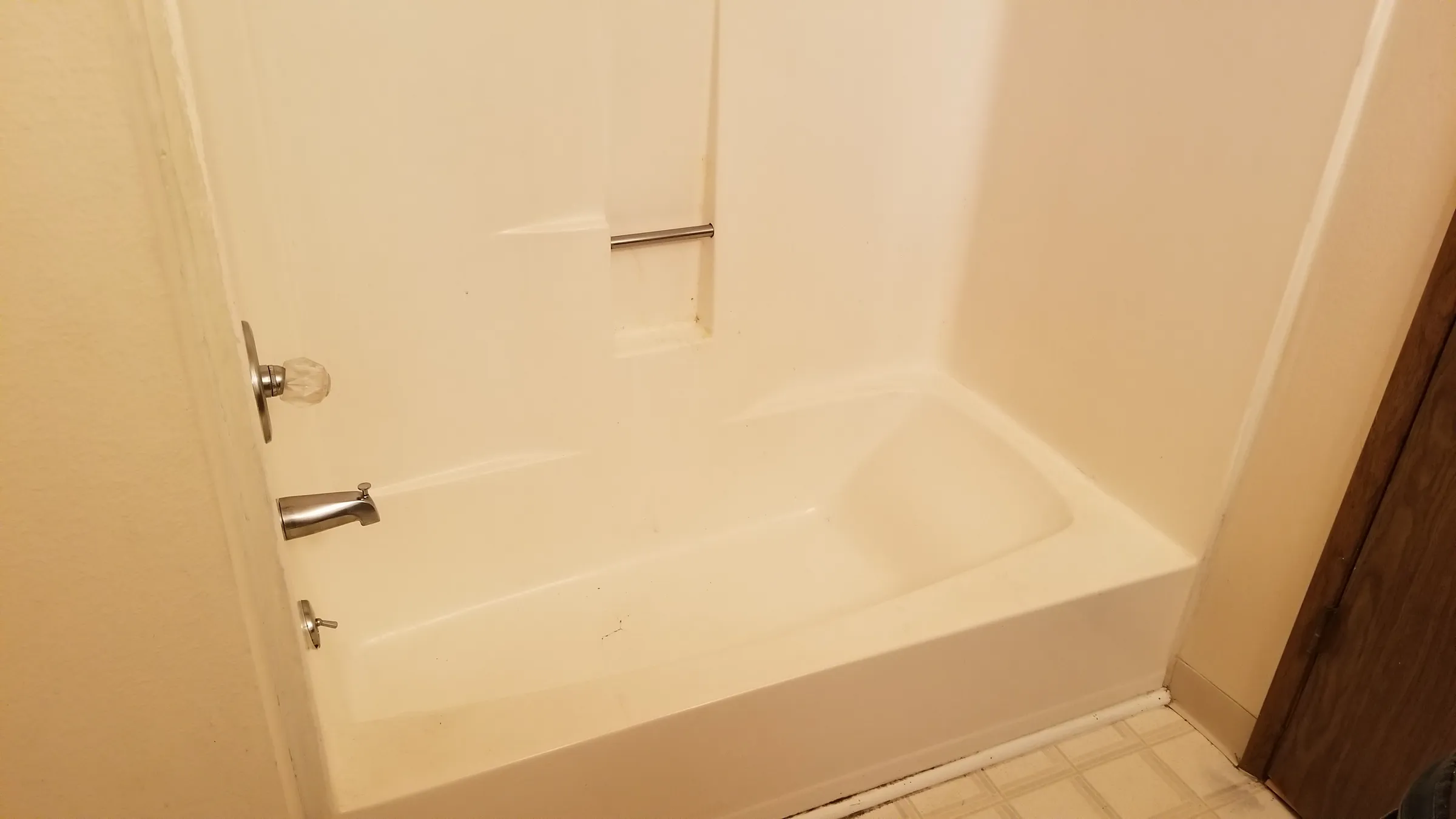 Before: the original tub and fiberglass surround.