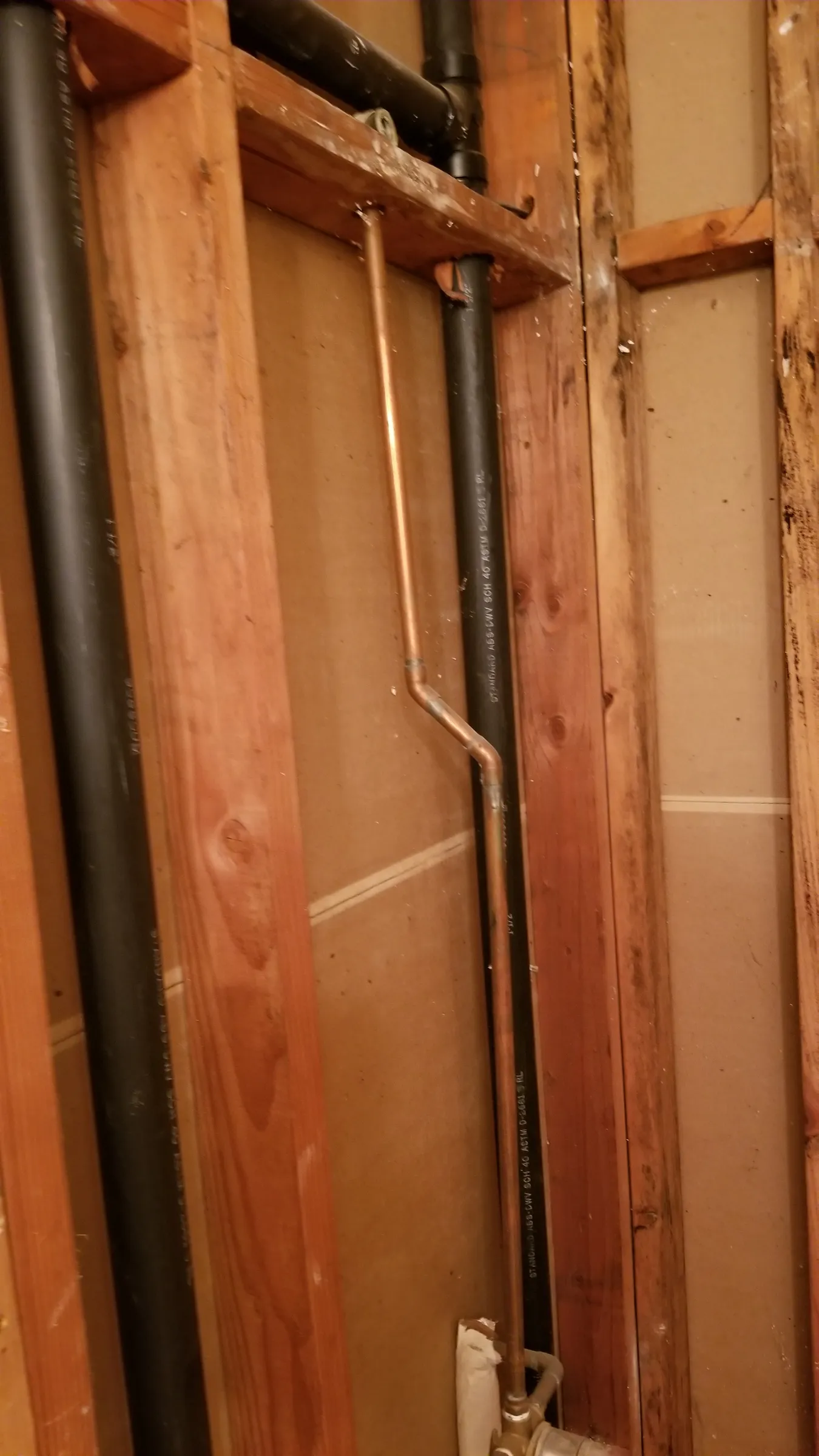 Supply and drain lines in the open wall.