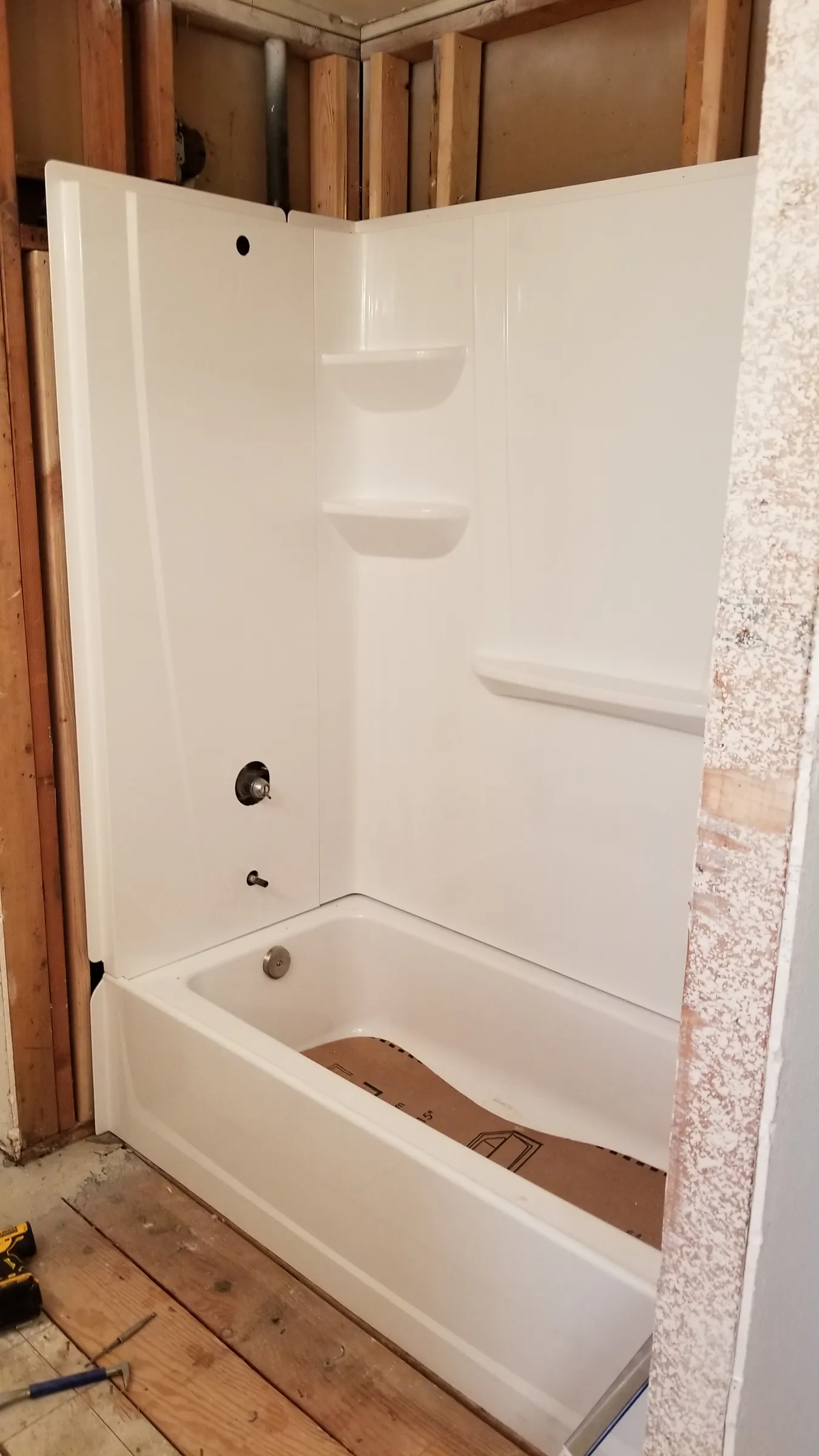 New tub and surround set in the alcove.
