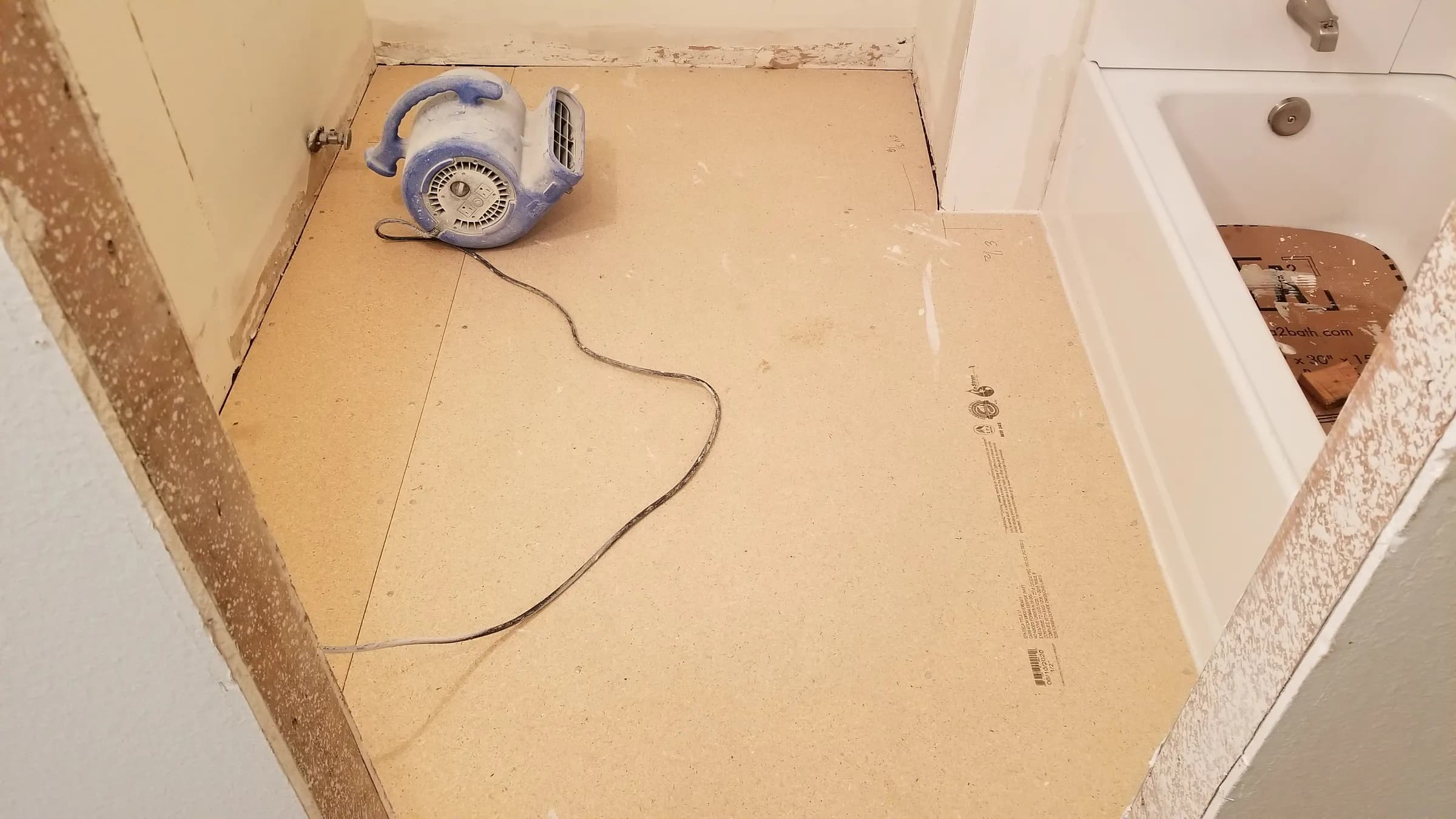 New underlayment down; fan drying the patches.