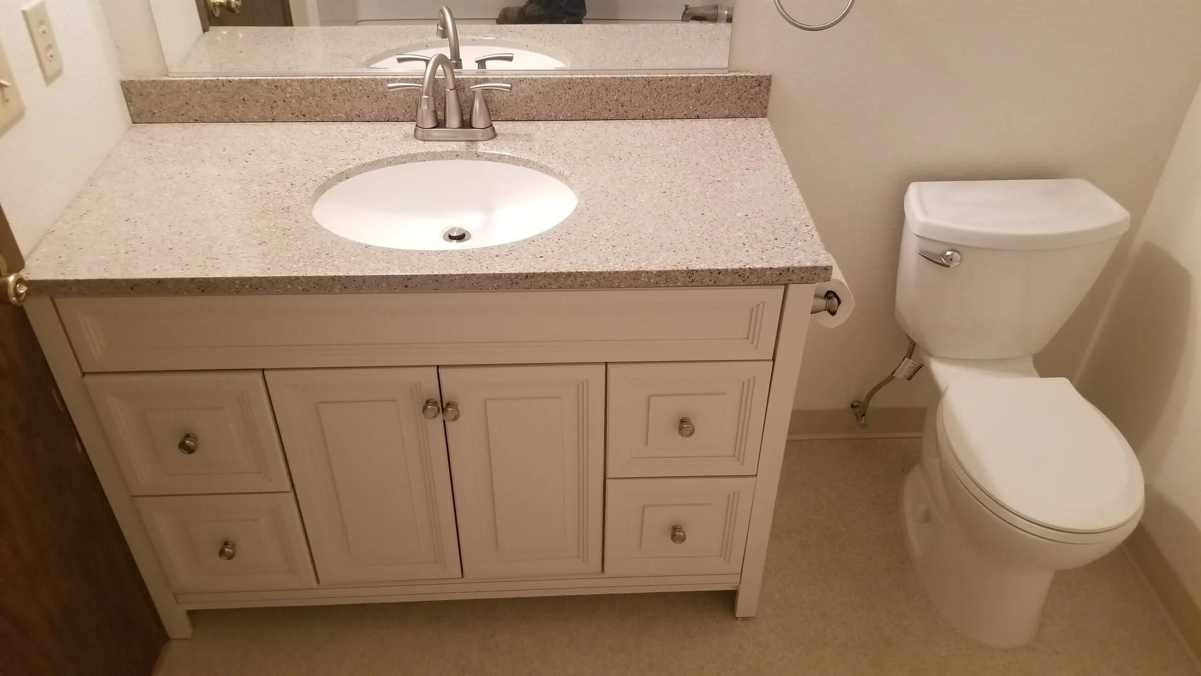 New vanity and toilet, same layout as before.