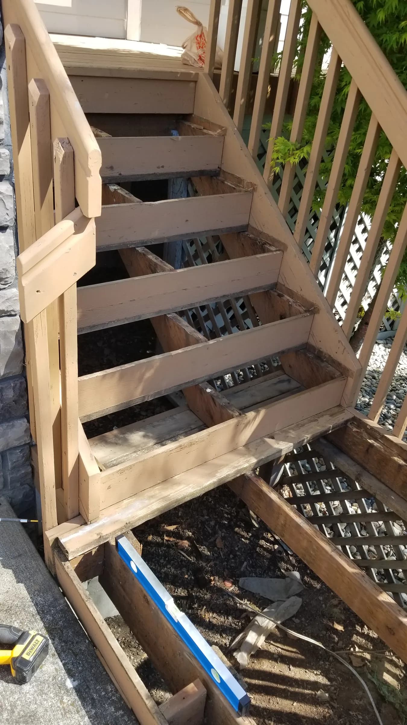 Demo: Stairs opened up — treads removed and the framing exposed for the rot repair.