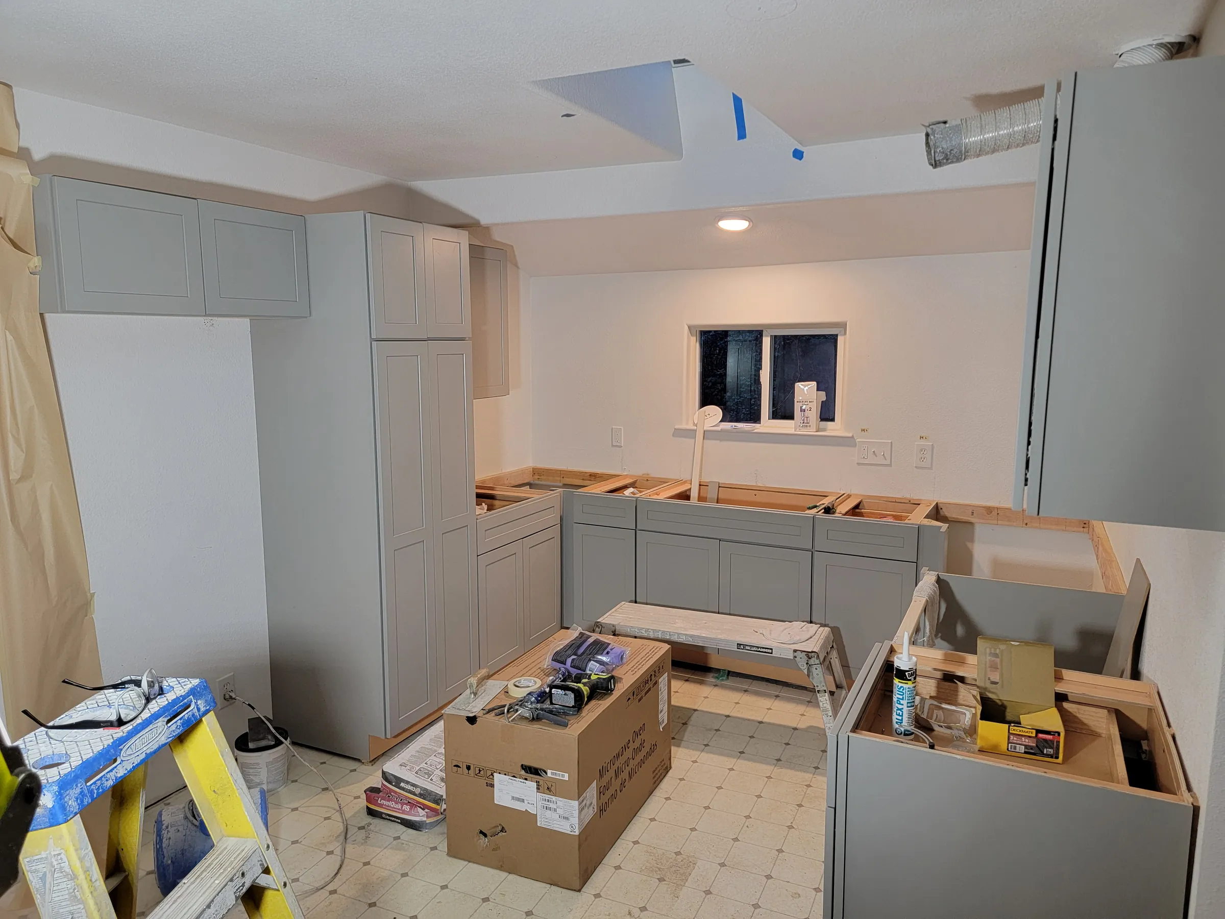 Install: Kitchen install under way — cabinets set, counters and island still to come.