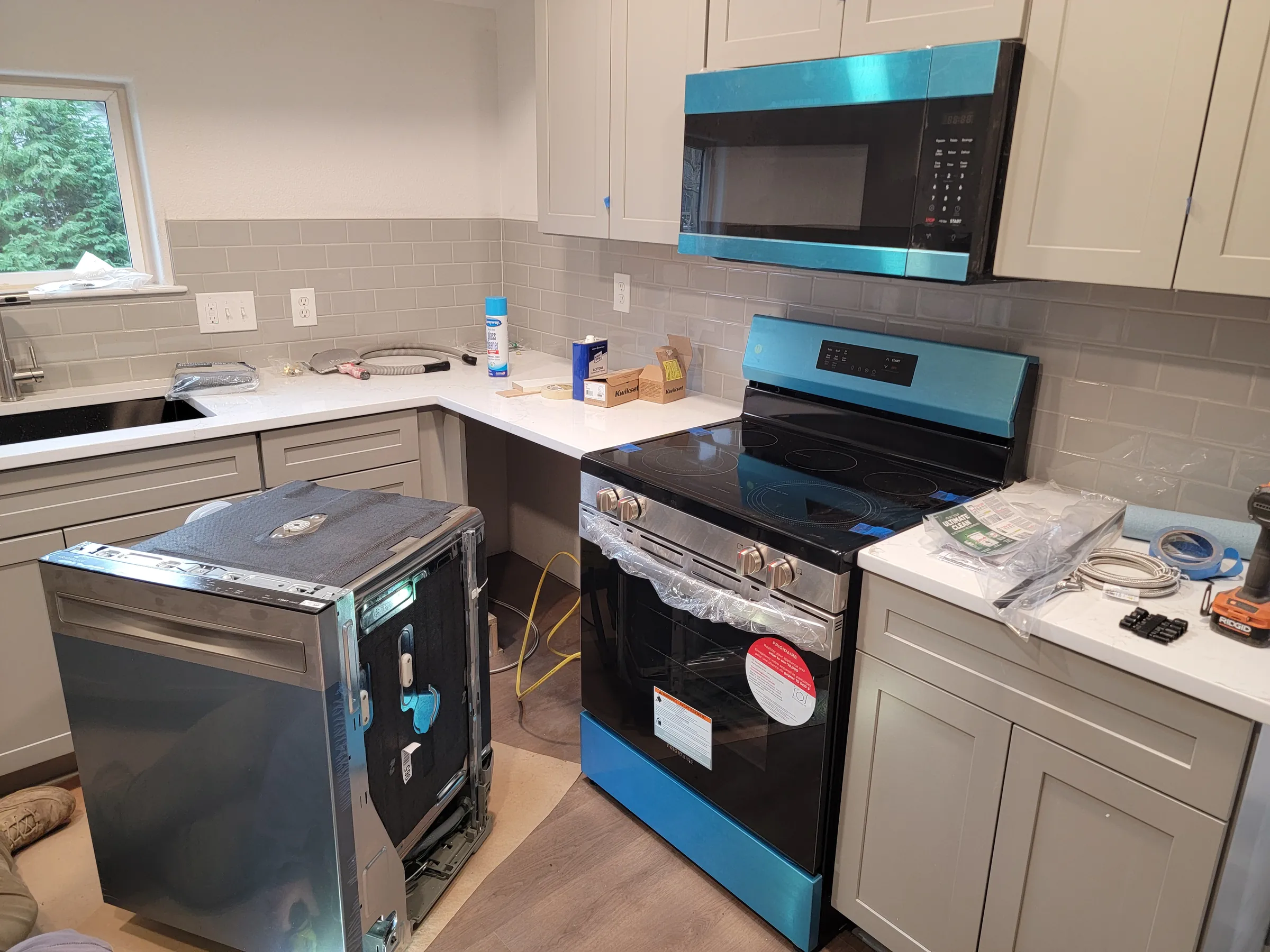 Install: Appliances landing — range still in its protective film.