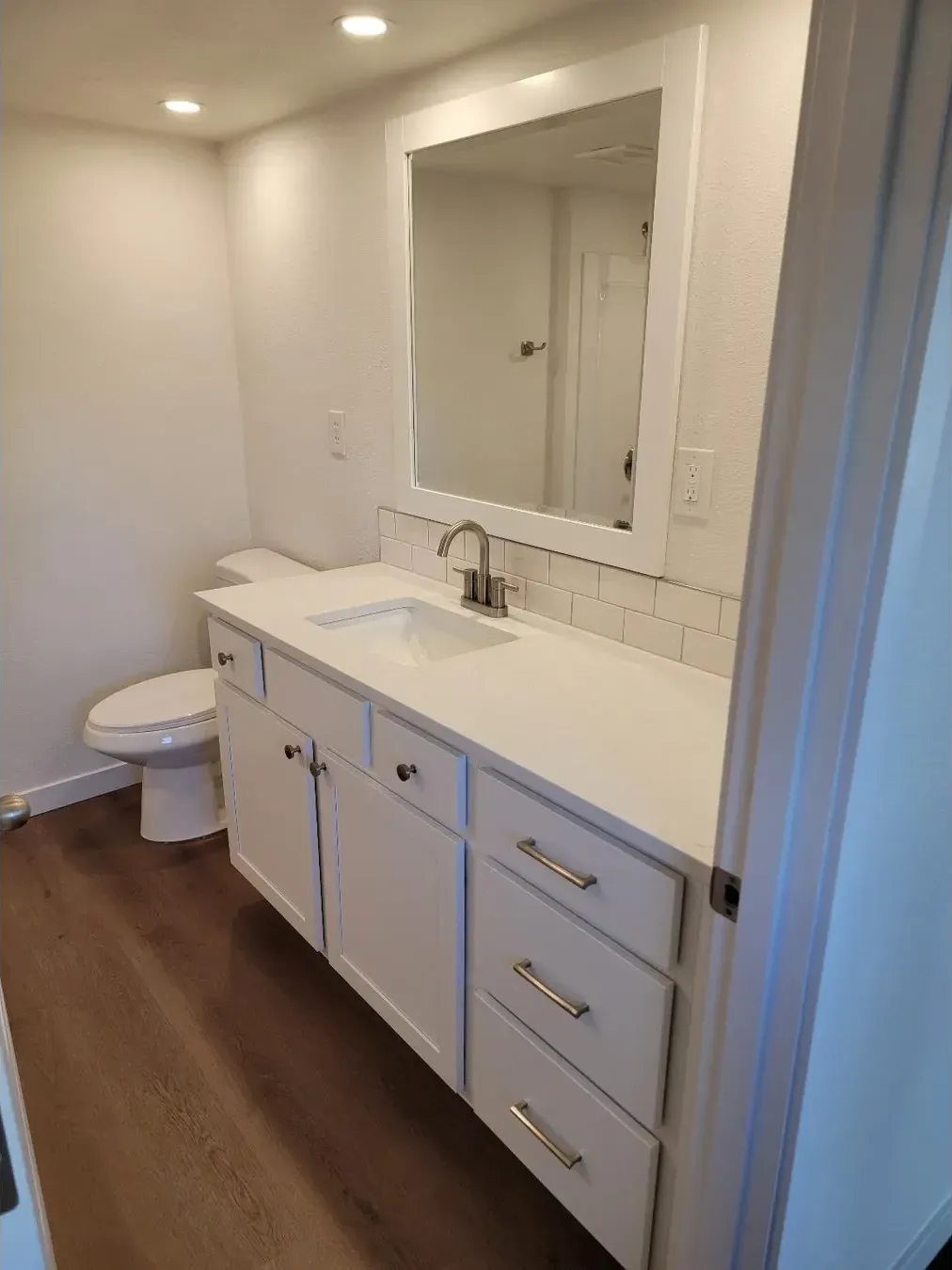 Done: Main bathroom — new double vanity and flooring.