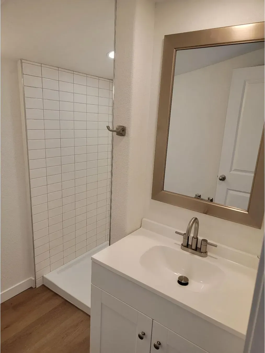 Done: Second bathroom — new vanity with the tiled shower.