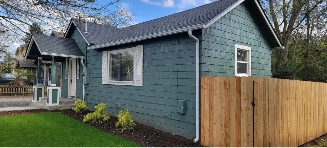 Done: Side elevation with the new fence (listing photo).