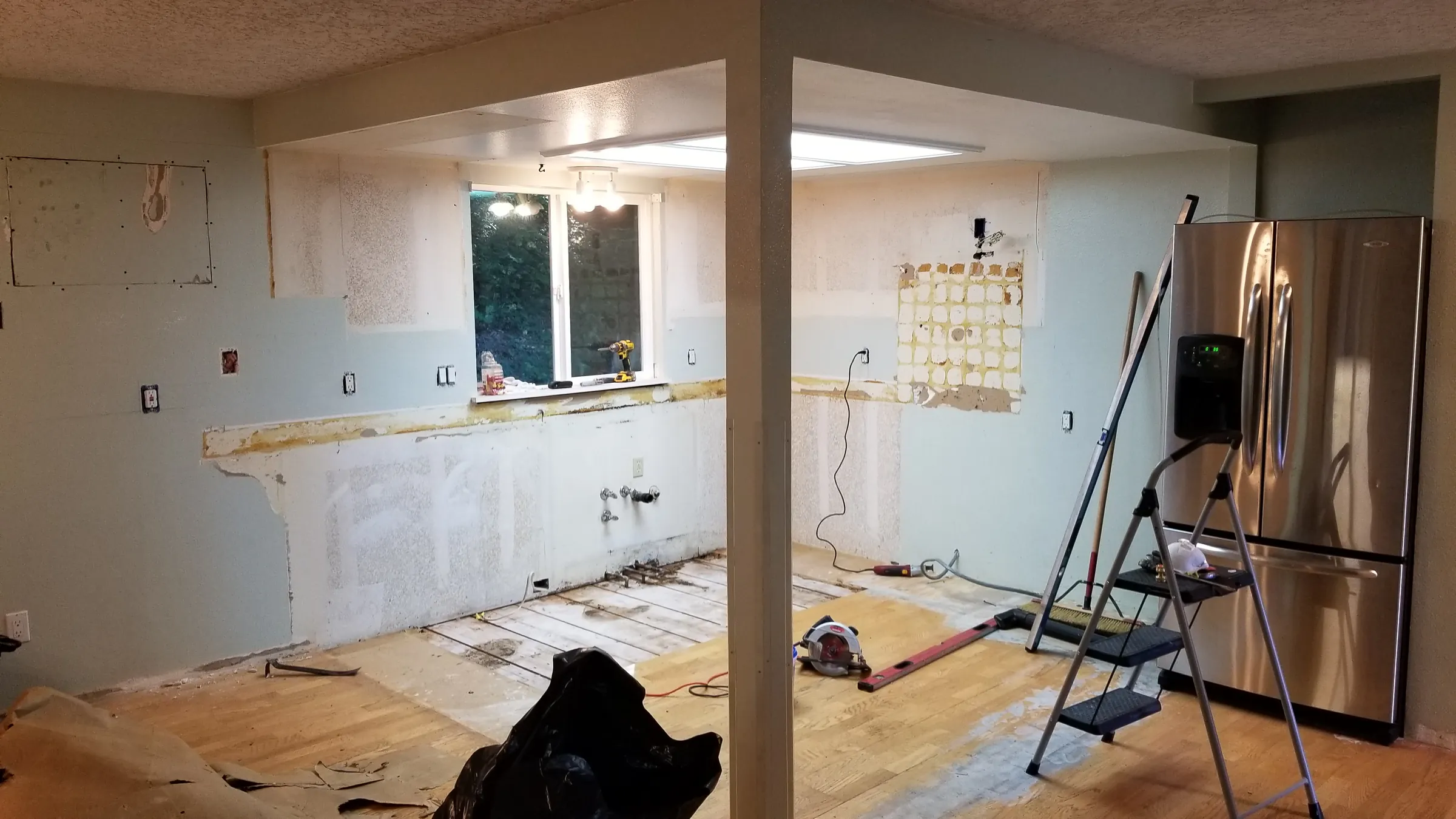 Demo: Cabinets coming out — the back wall opened up and the backsplash stripped.