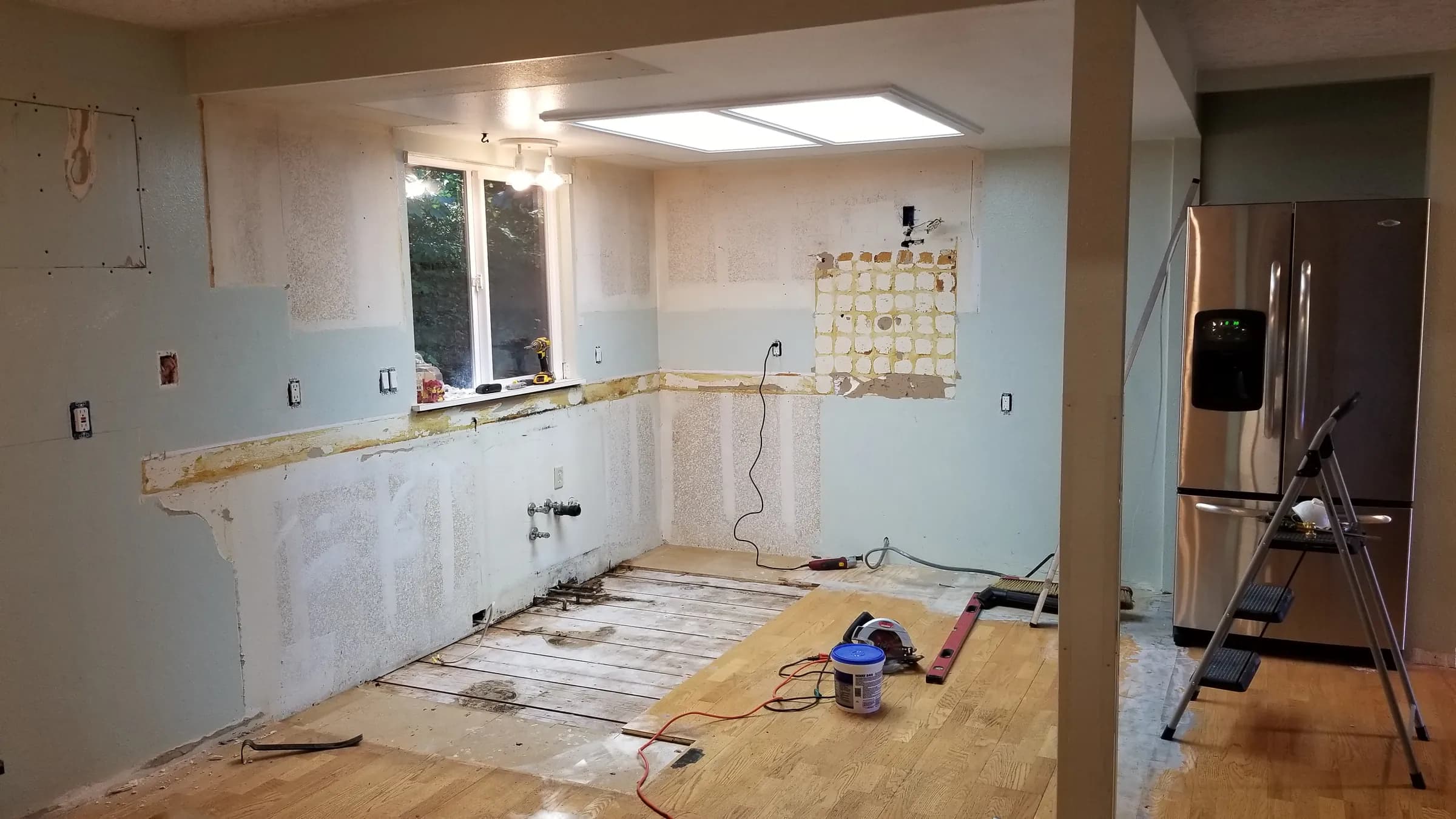 Demo: Back wall stripped and flooring coming up.
