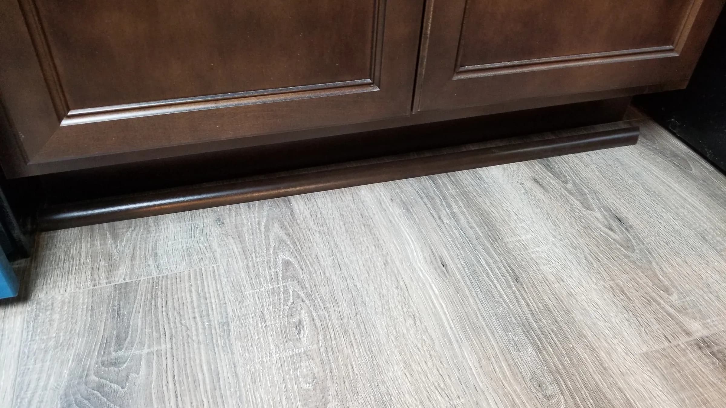 Floor: Toe-kick and new plank flooring detail.