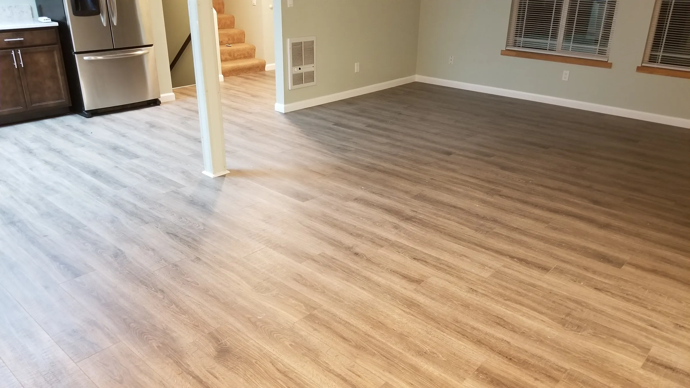 Floor: New flooring flowing from the kitchen into the living area.