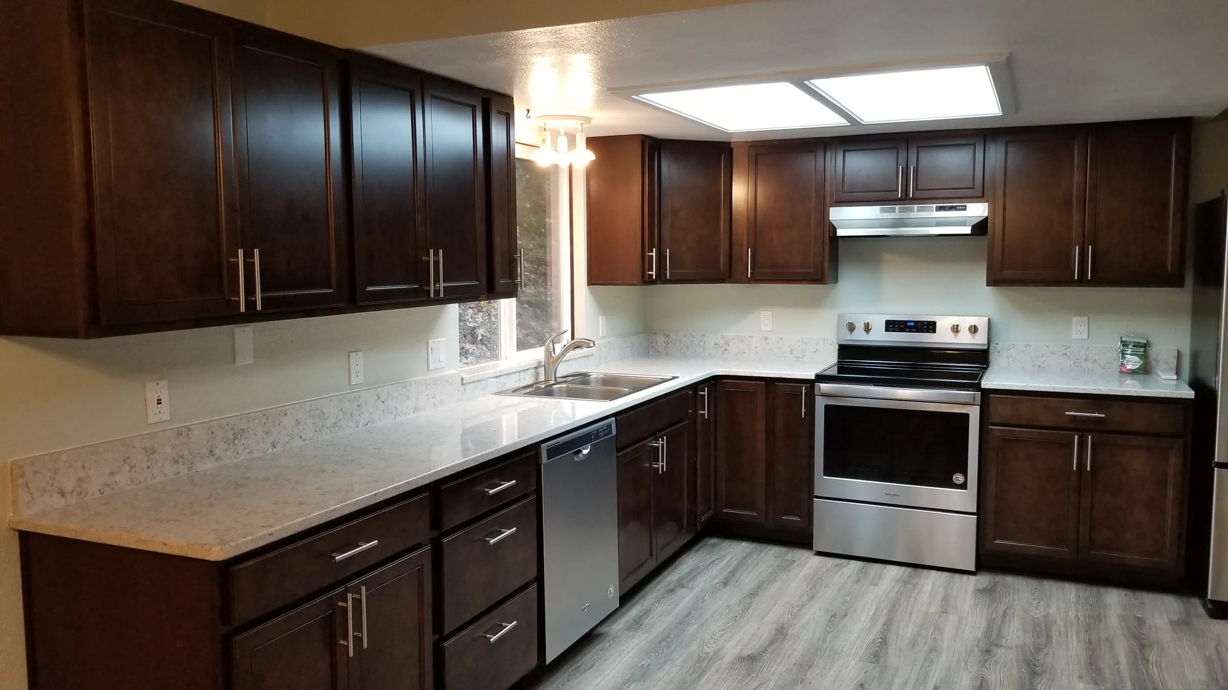 Done: The finished counter run — sink, dishwasher, range.