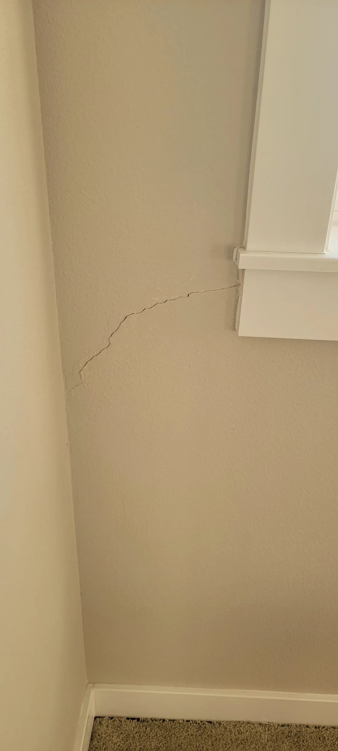 Before: The settlement crack under the window corner