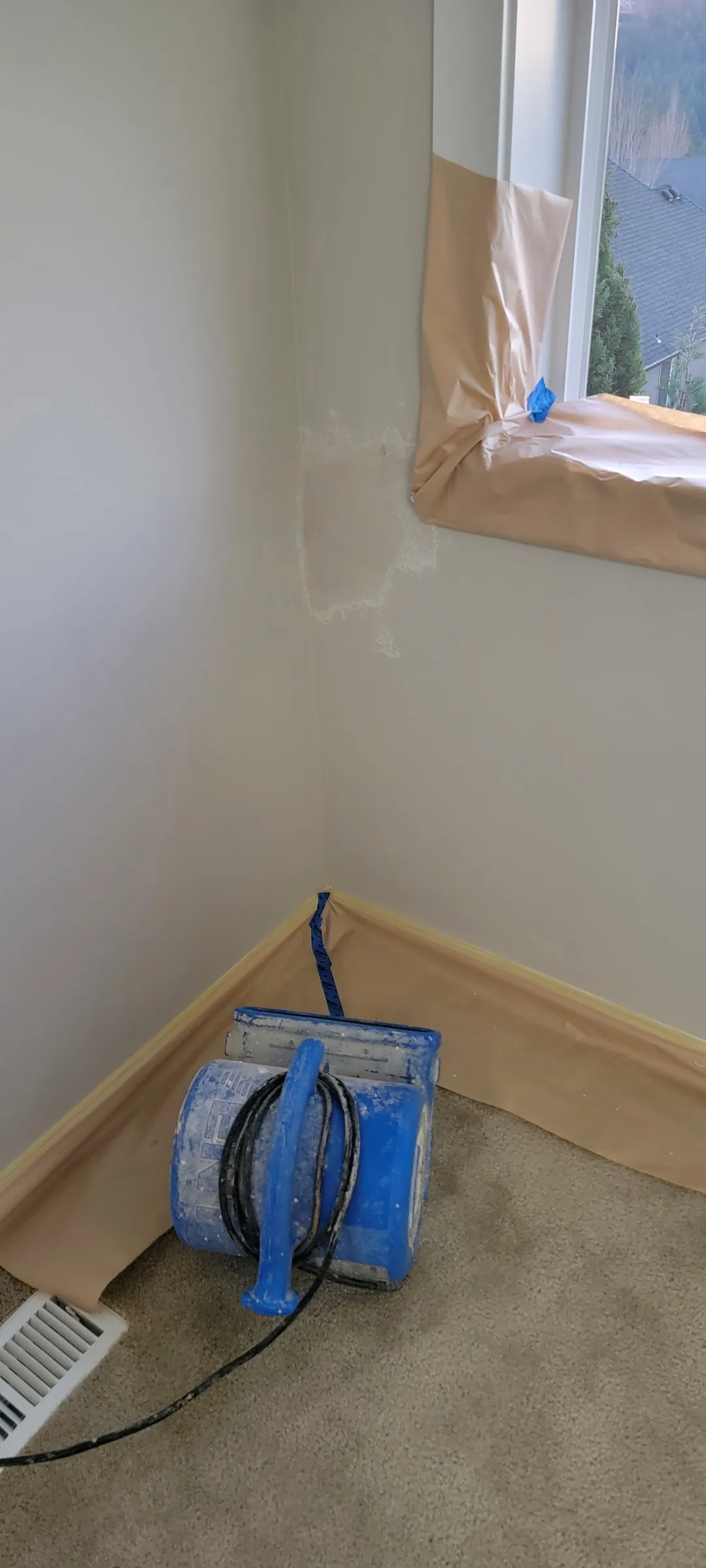 Repair: Corner masked off, repair under way, fan drying