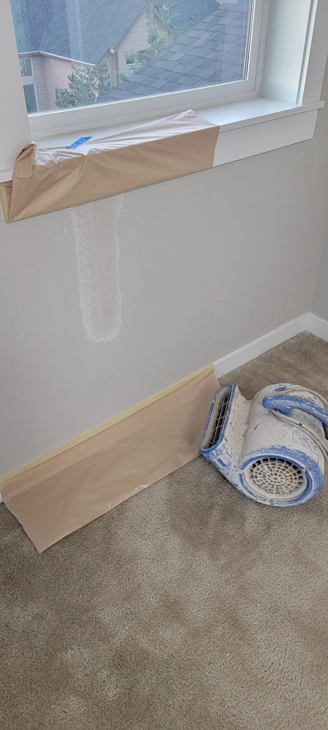 Repair: The second crack, under the wide window — patch drying, fan on it