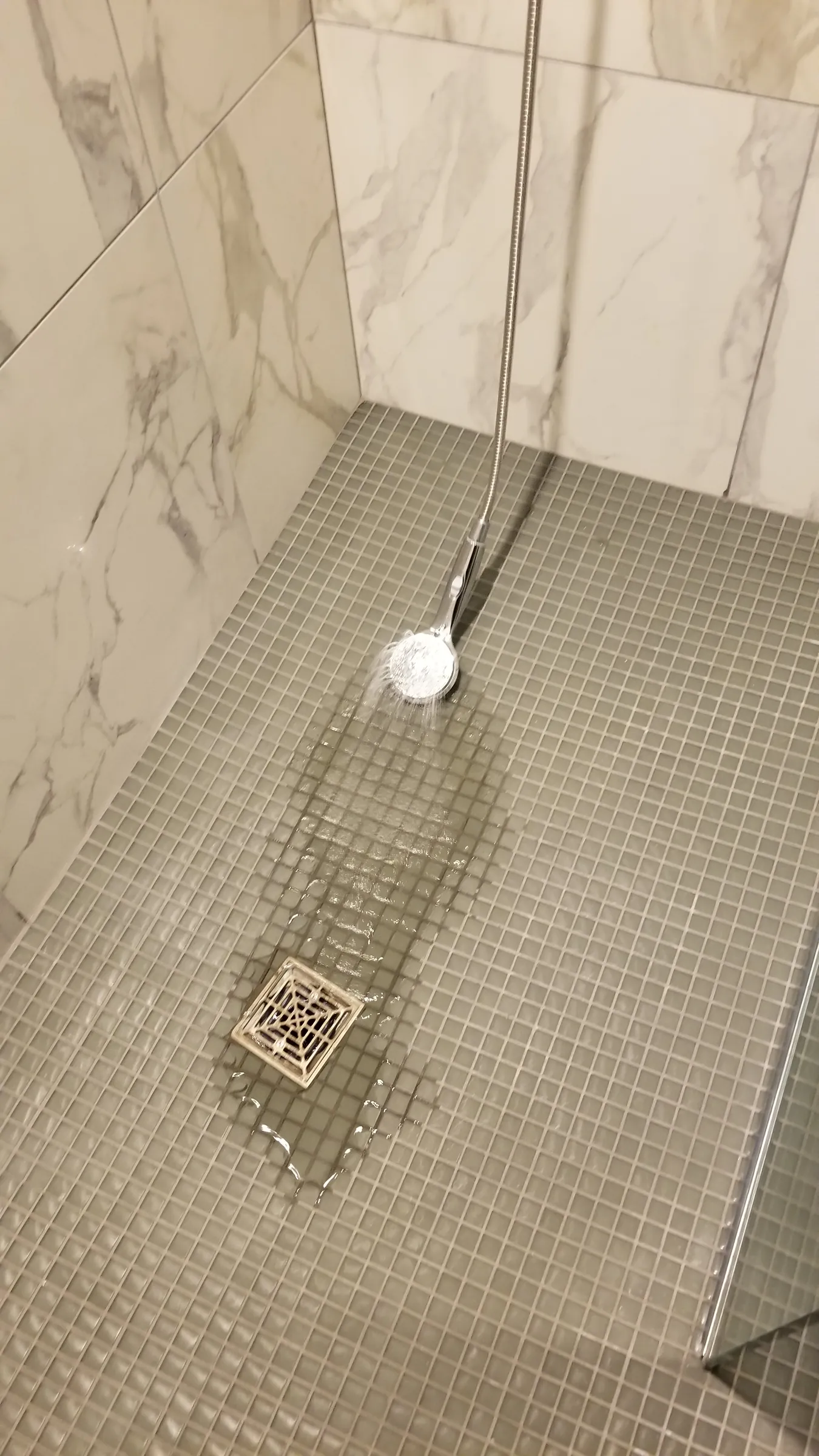 Before: Flood-testing the shower — water running to the drain.
