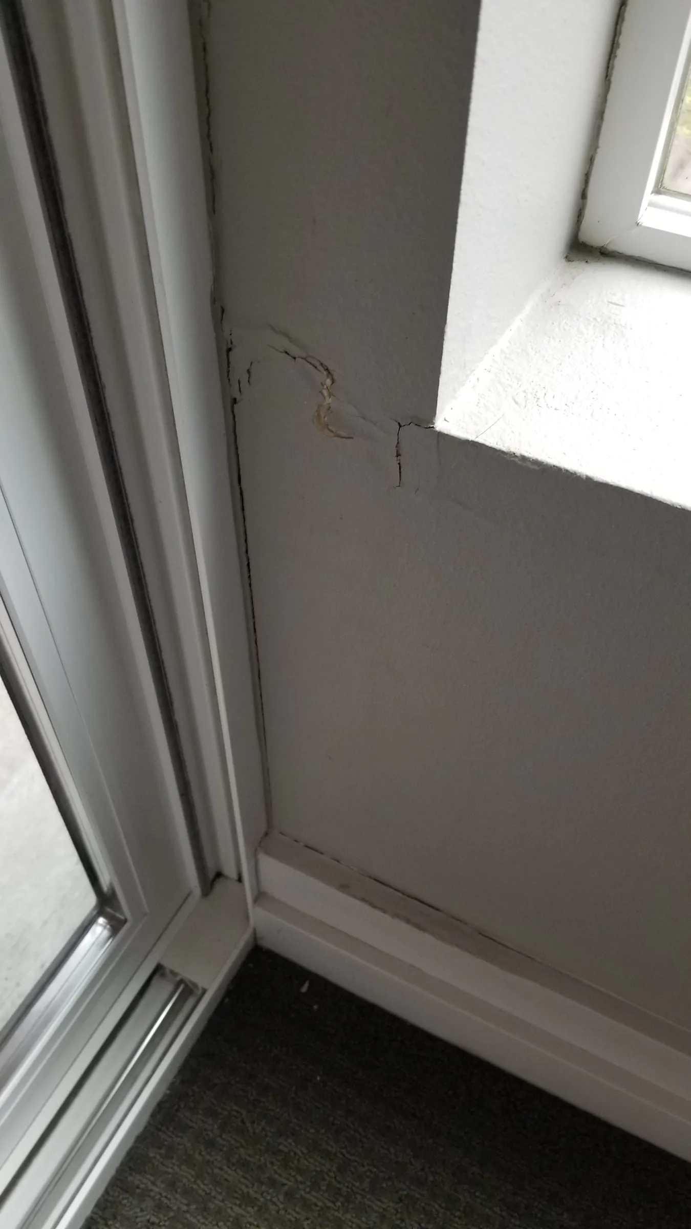Before: Cracked, bubbling paint below the window — the damage that started the job.