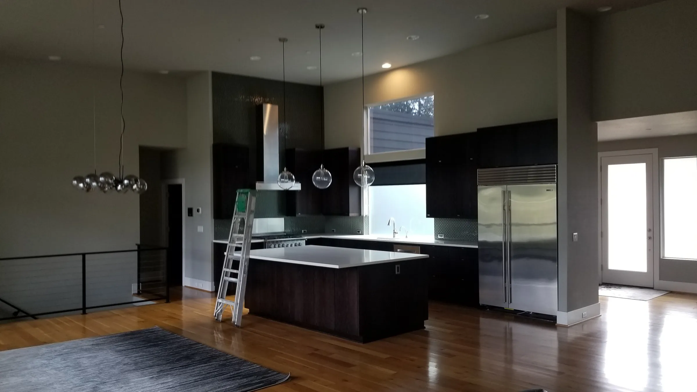 Before: The kitchen before work — dark cabinets and island.