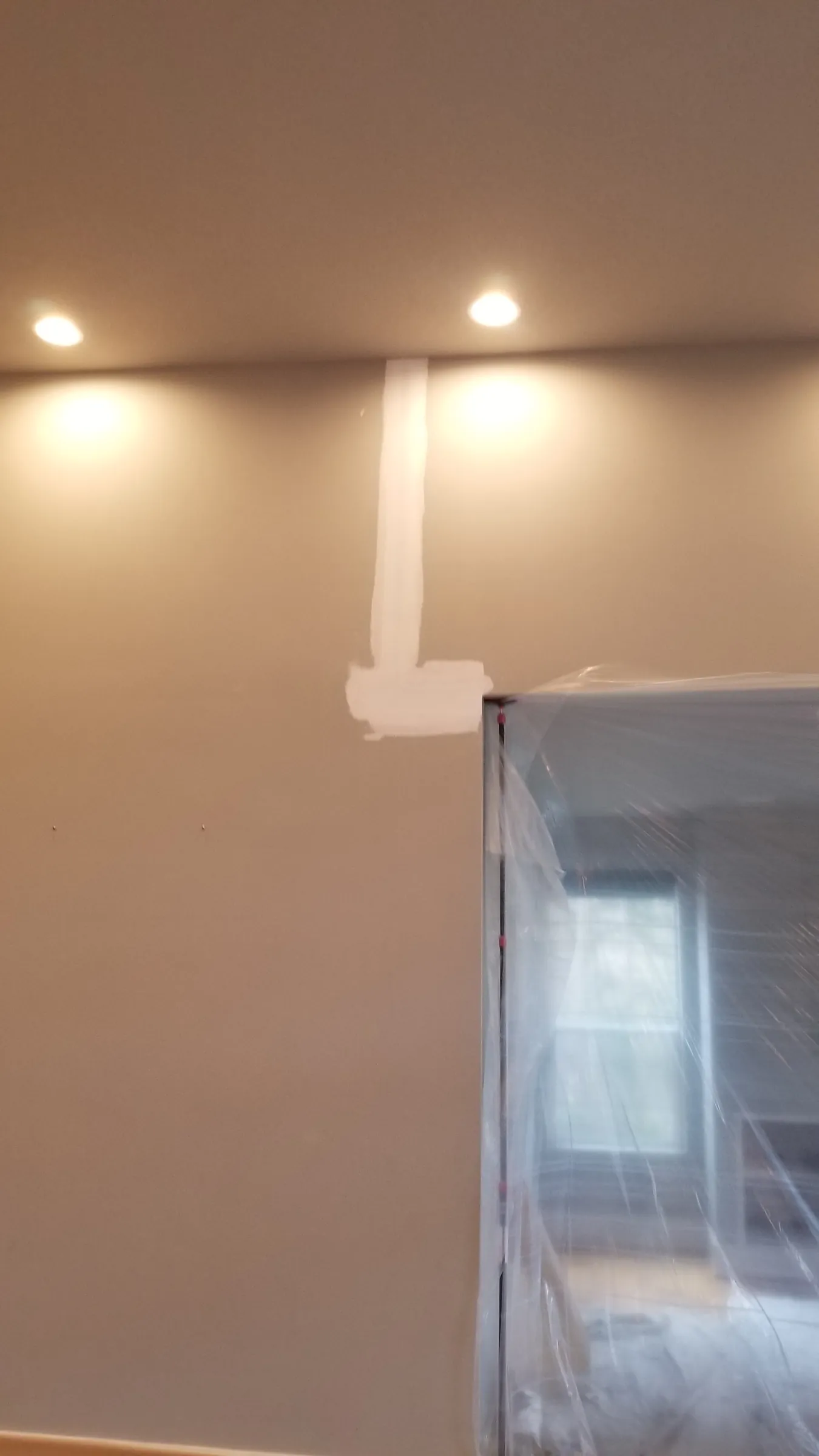 Repair: Fresh drywall patch floated on the living-room wall.