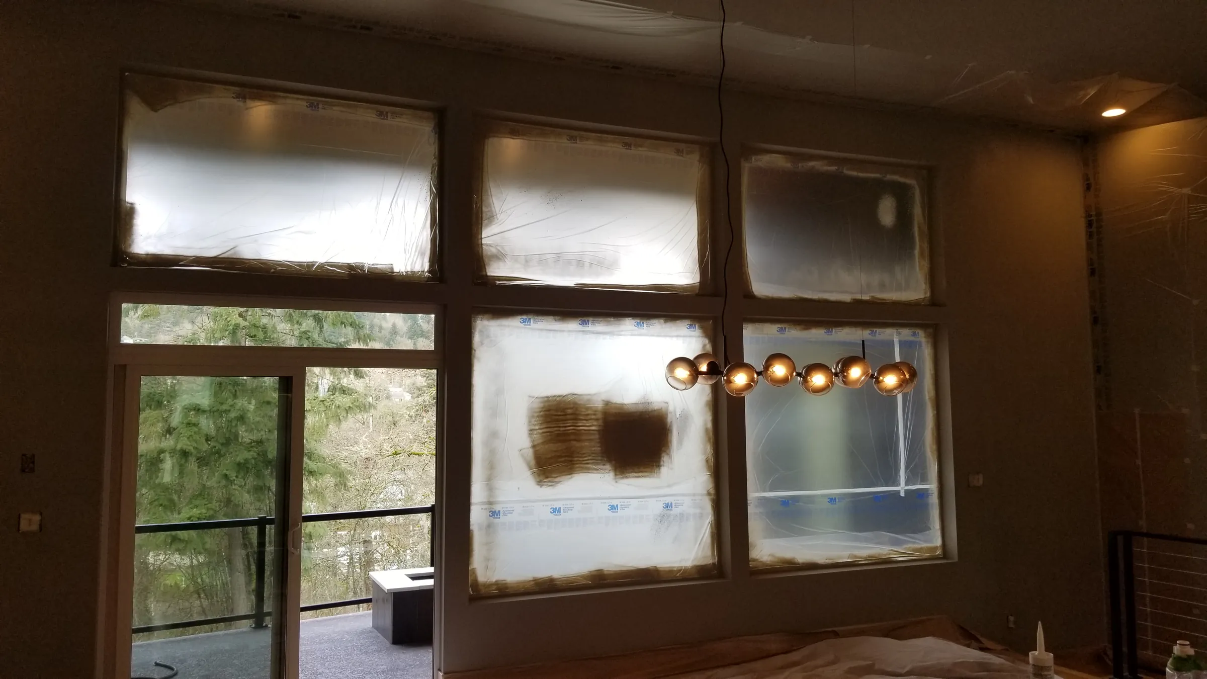 Repair: Drywall patches curing behind the window film.