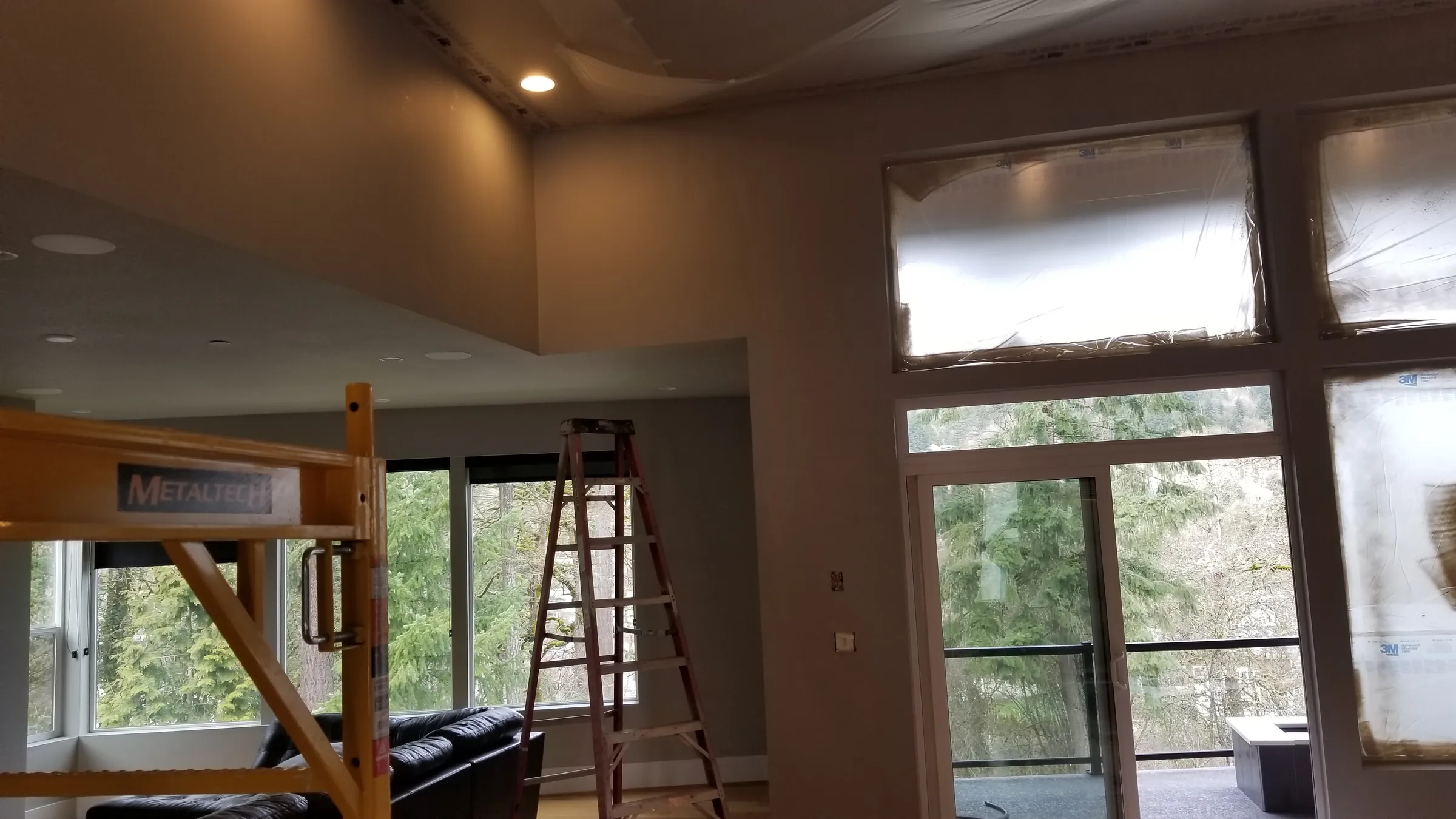 Paint: Scaffold and ladders at the tall window wall.