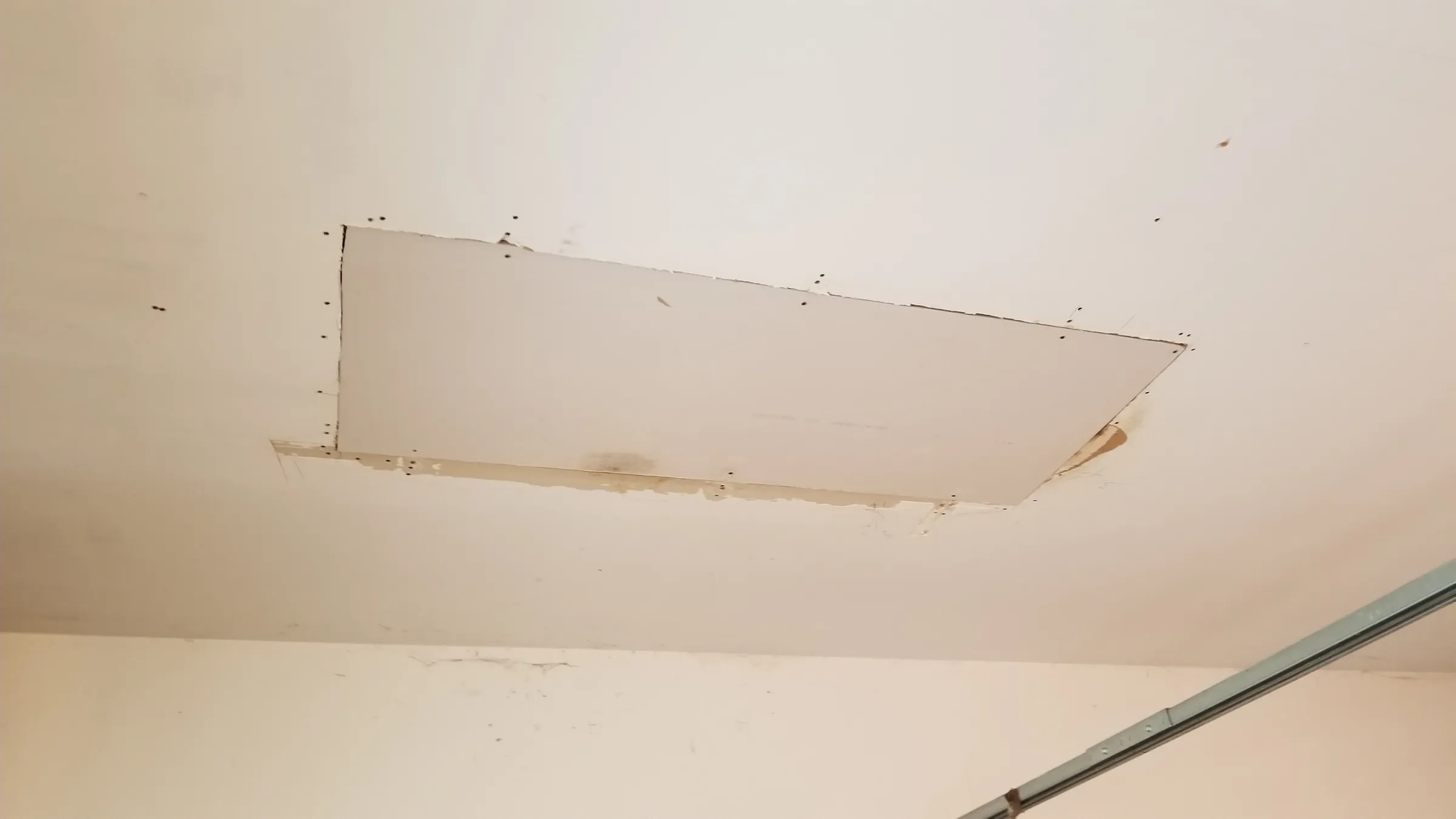 Repair: Garage ceiling cut open where the leak came through