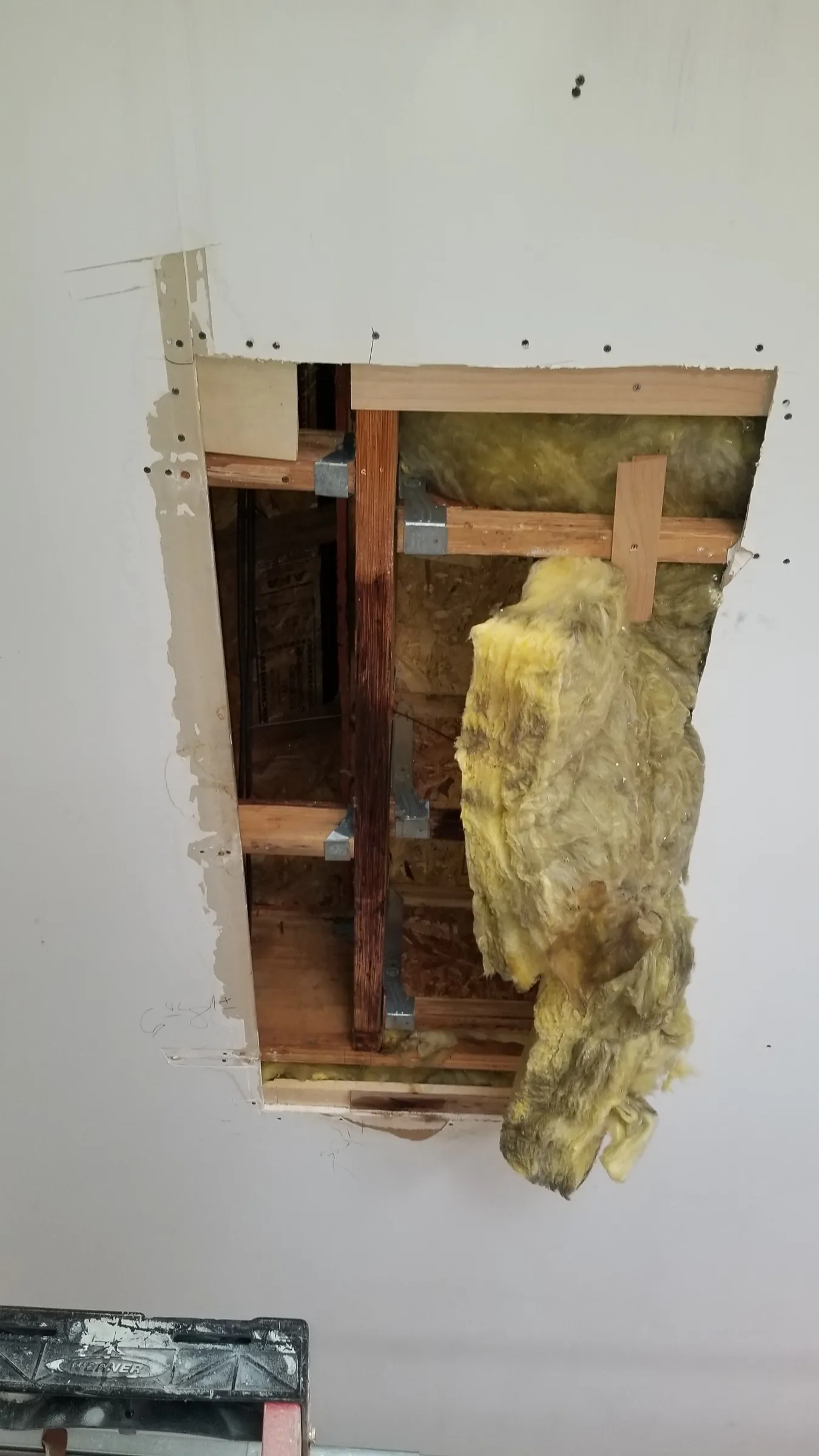 Repair: Wall opened at the corner, insulation out