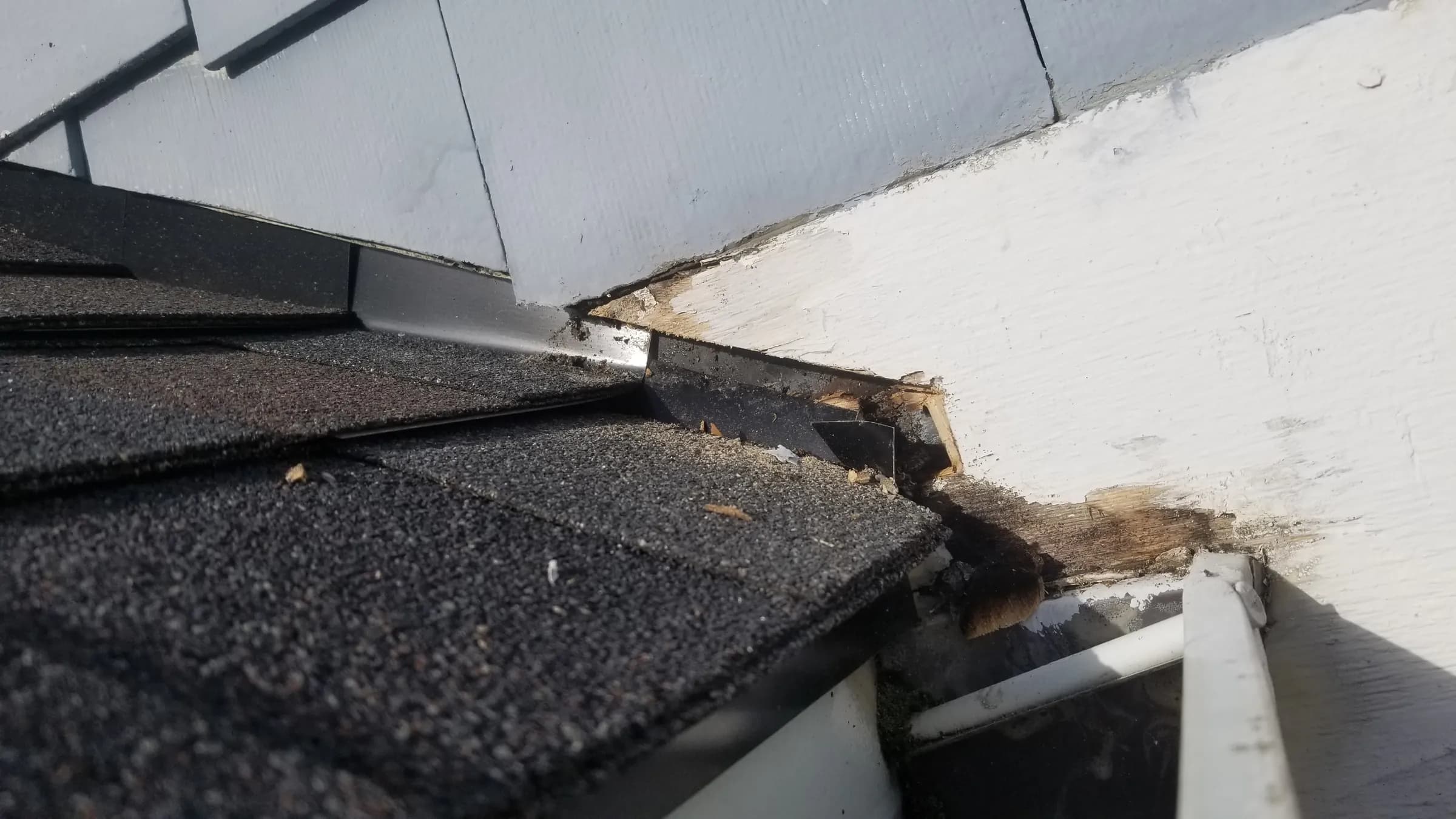 Before: The kickout area — rot where the roof meets the wall