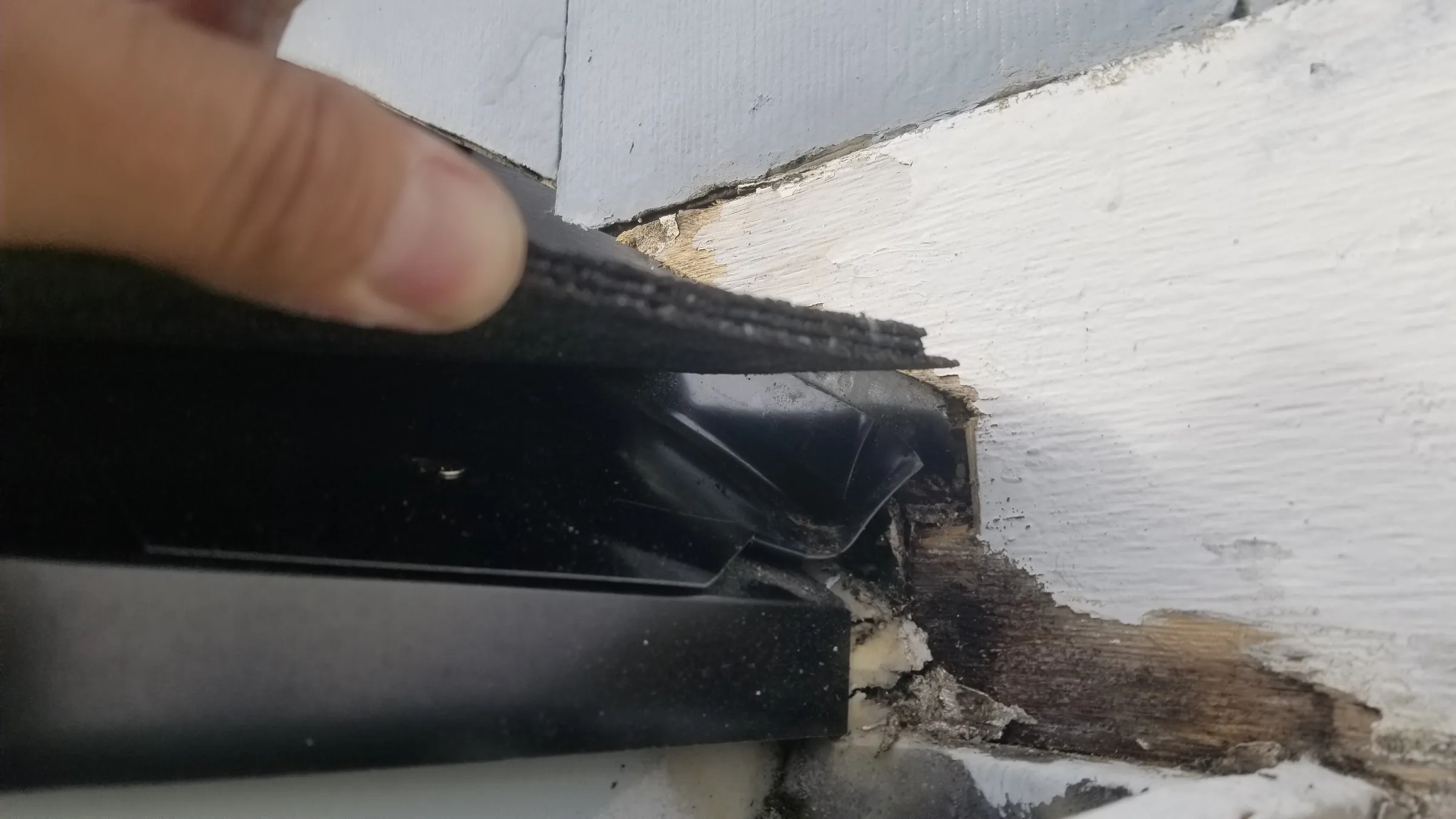 Before: Lifting the flashing at the failed kickout — the water entry point