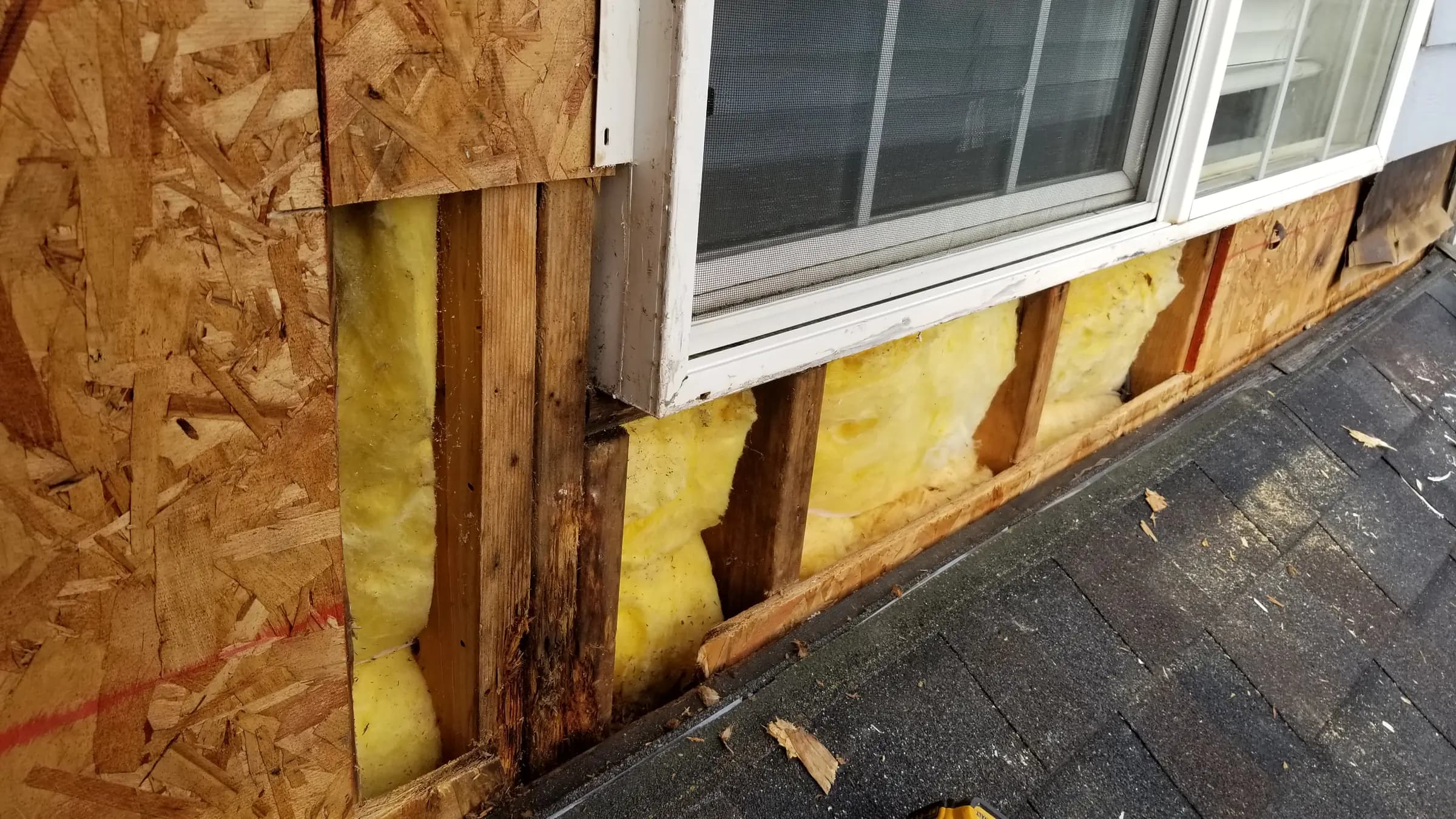Install: Wall opened — framing sound, new sheathing going in